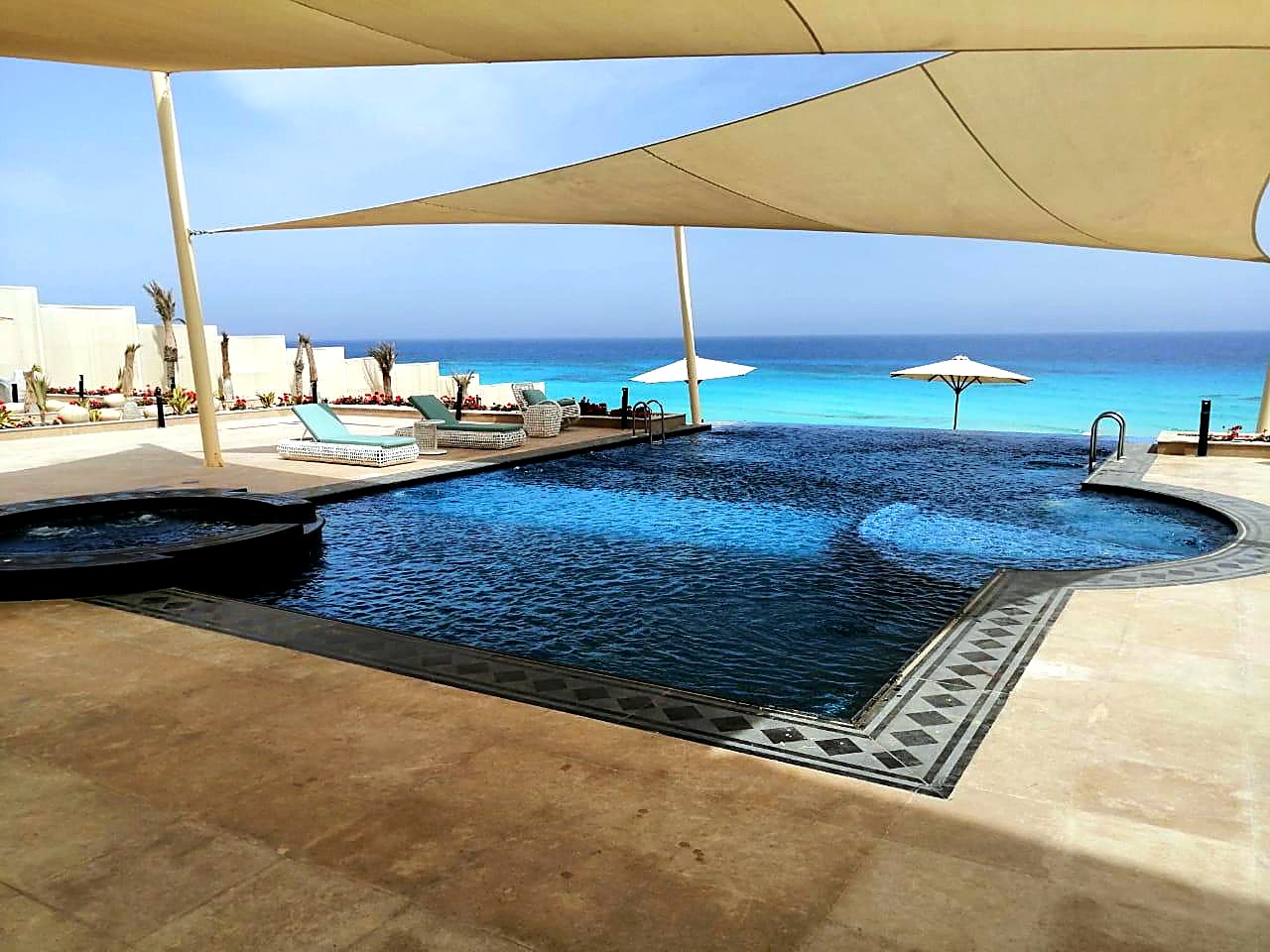 Infinity pool overlooking the sea with lounge area