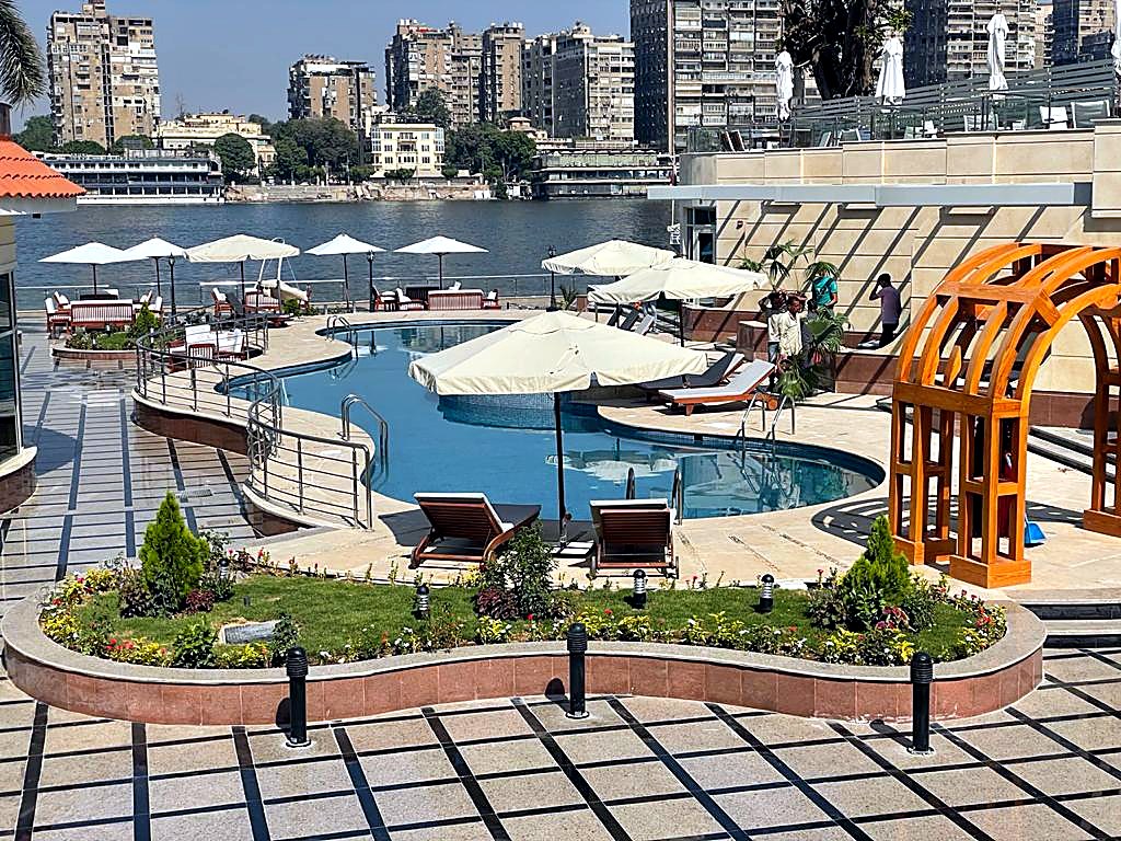 Hotel pool with cream umbrellas and loungers